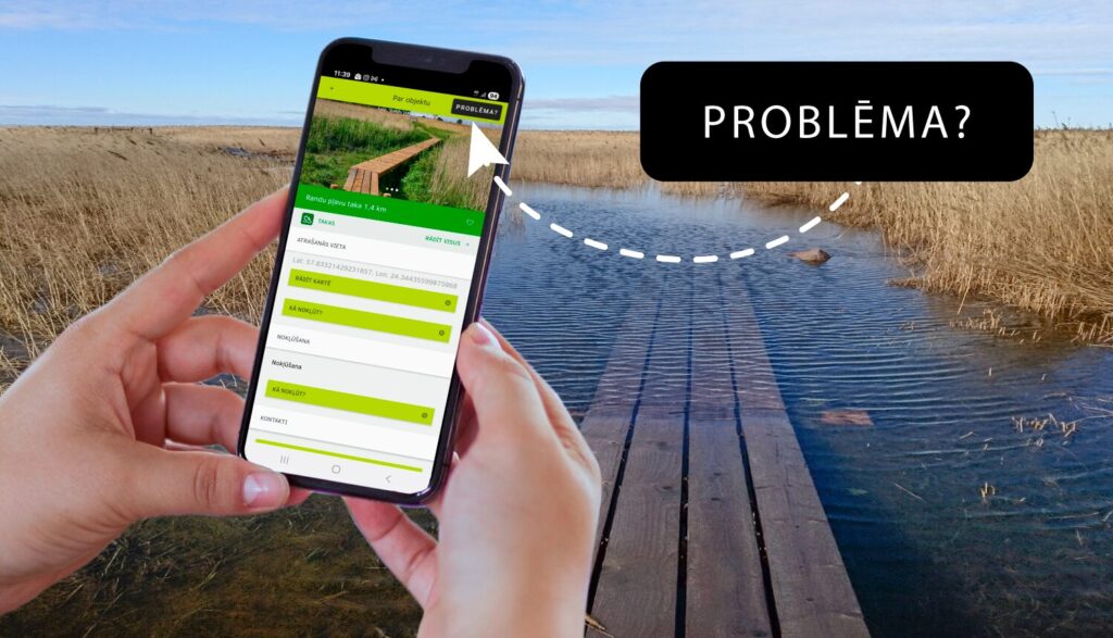 Fonā dabas skats, priekšplānā rokas, kas tur viedierīci.