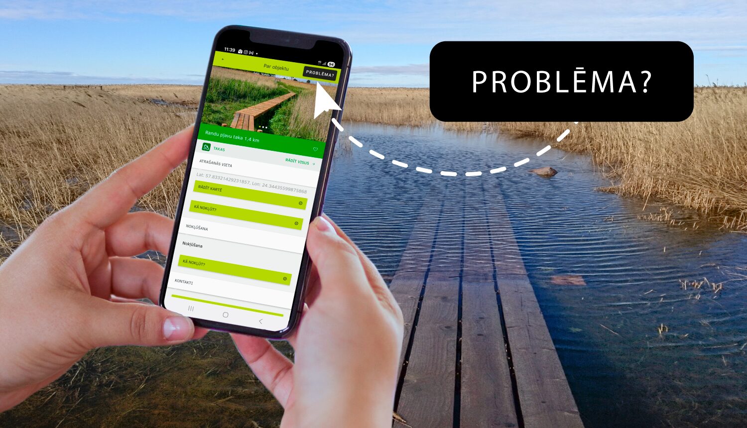 Fonā dabas skats, priekšplānā rokas, kas tur viedierīci.